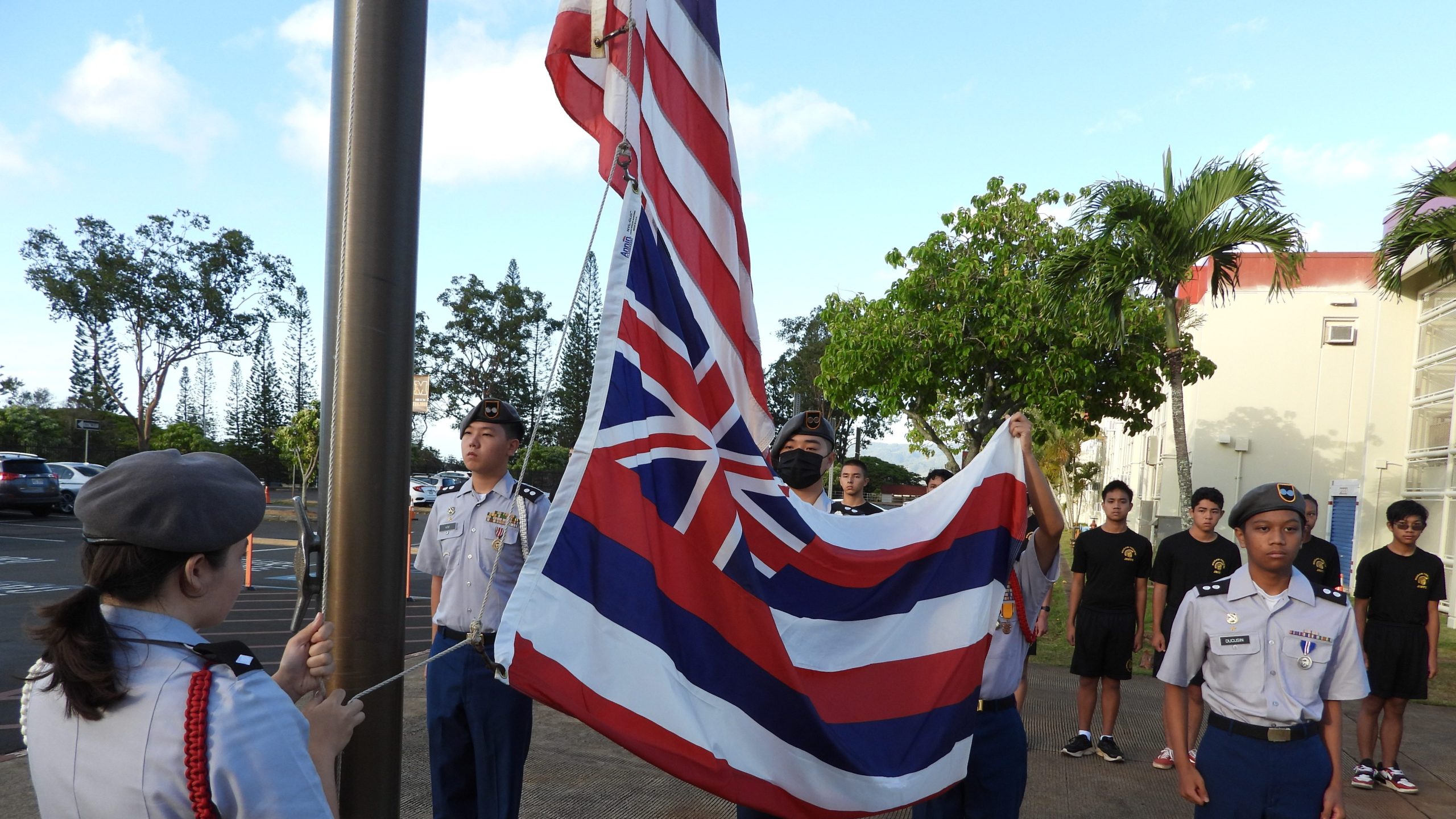 Cadets of the Trojan Color Guard prepare to raise the American and Hawaiian Colors