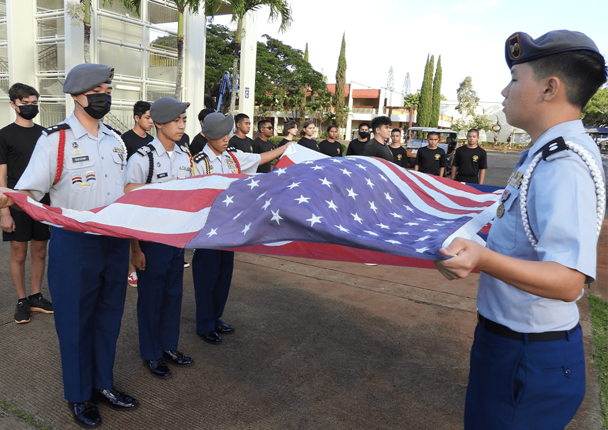 Cadets of the Trojan Color Guard prepare the colors