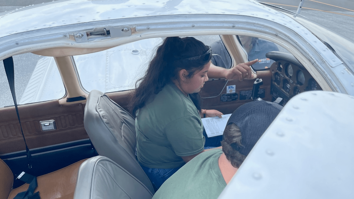 Cadet Daniella Huato-Morales conducts a maintenance check prior to flight operations.