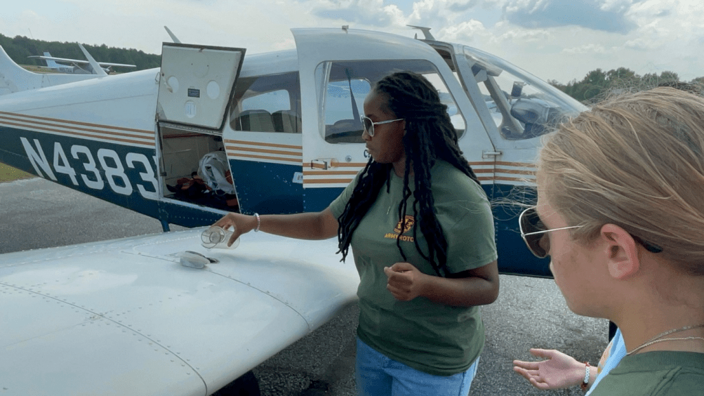 Cadet Kennedy Hosley conducts a fuel inspection prior to take off.
