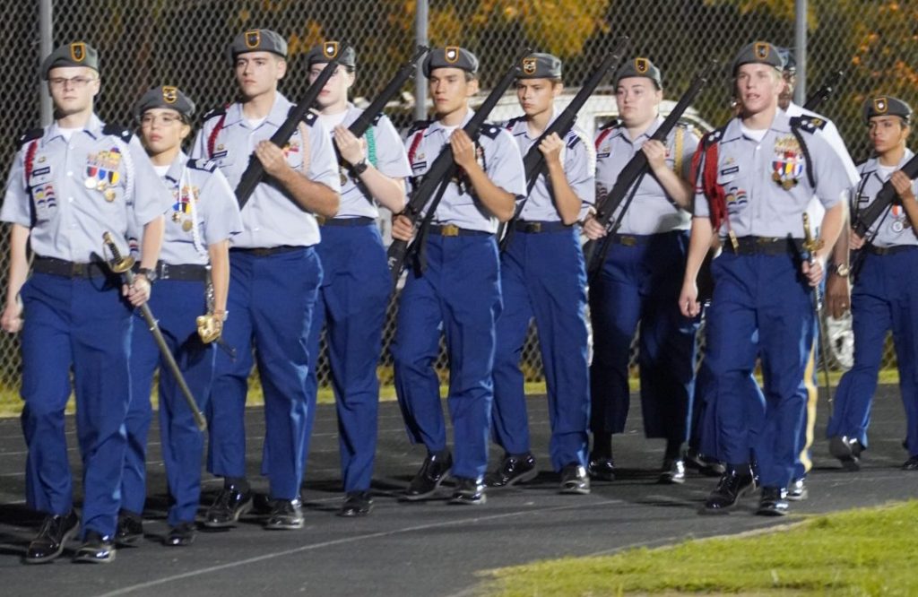 Butler JROTC Honor Guard marching off of the football field