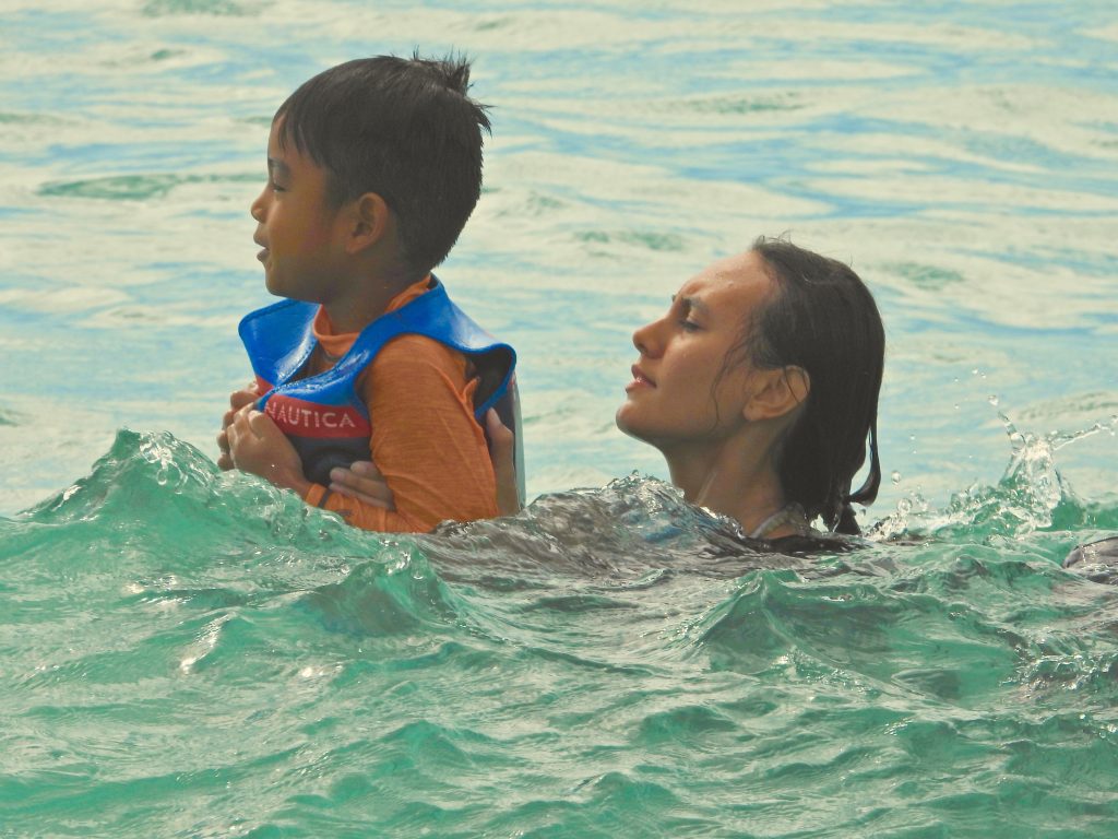 LET 2 Sophomore Cadet Destiny Krieger assist a young participant with Swimming