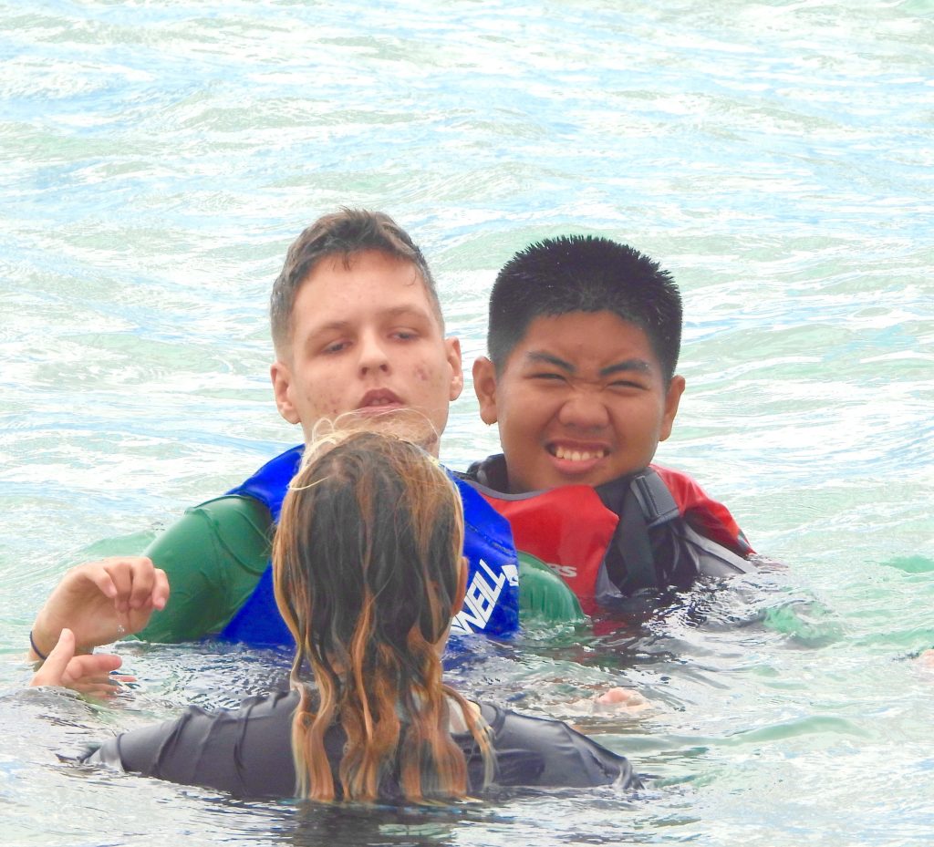 LET 2 Senior Cadet Captain Ceejay Jaramillo, Battalion S-2, assists a participant with Swimming
