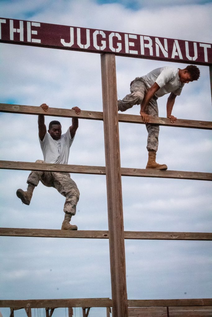 Team competing on the obstacle course high climb
