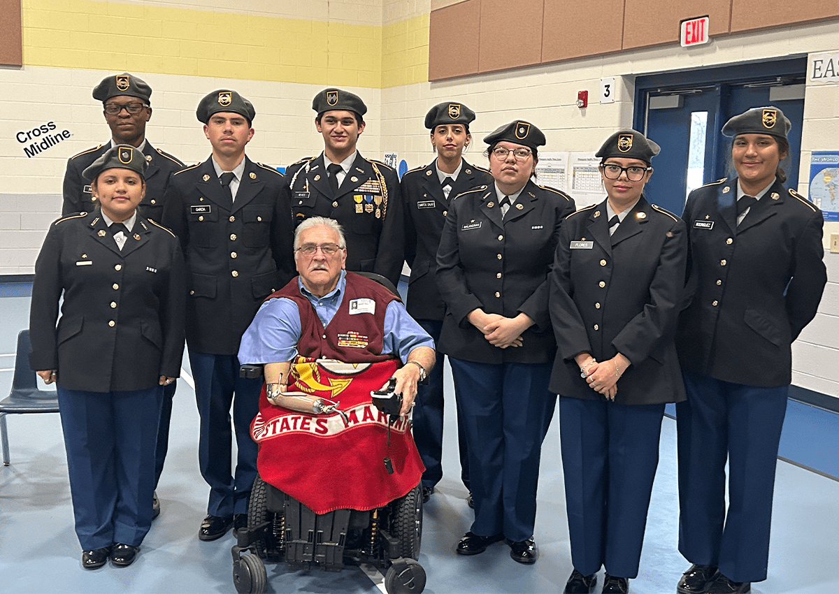 Cadets of the DHJ Eagle BN stand for a photo shoot with Vietnam Veteran, Marine Sgt Vincent Rios
