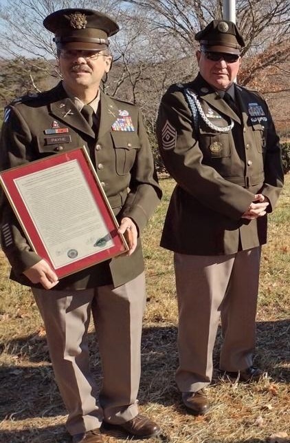 LTC (R) Payne and 1SG (R) Hutton receive the proclamation certificate on behalf of the program.