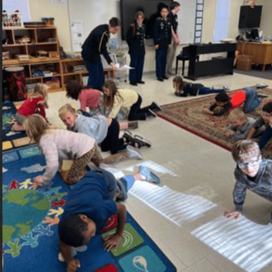 Husky Battalion Cadets teach students how to exit a smoke-filled room.