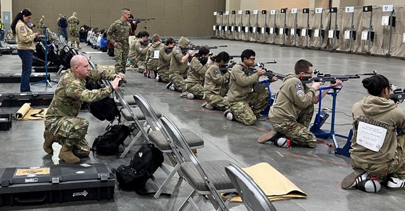 A JROTC instructor observes his team competing in the Sporter division. JROTC instructors’ continuous involvement and observation was critical in helping Cadets adjust during the competition.