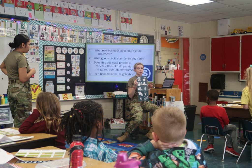 Cadet Madison Farris and Cadet Maria Palma teaching Junior Achievement