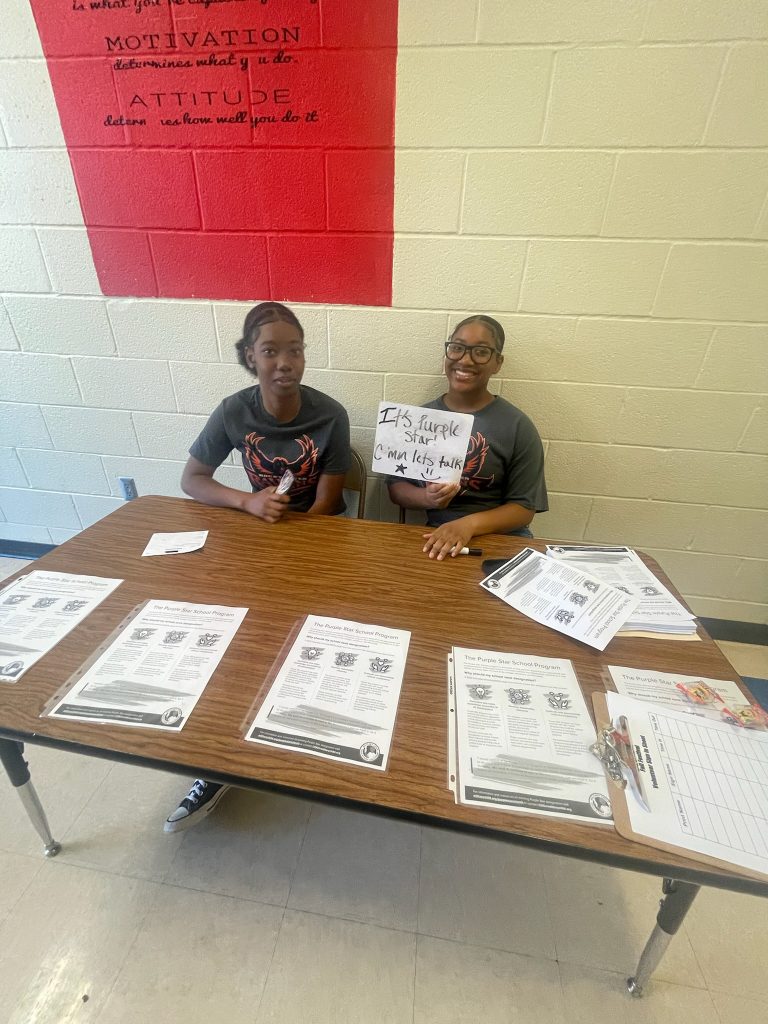 Cadet's Johnson and Biagas advertises Purple Star Families at Reedy Creek Elementary Fall Festival.