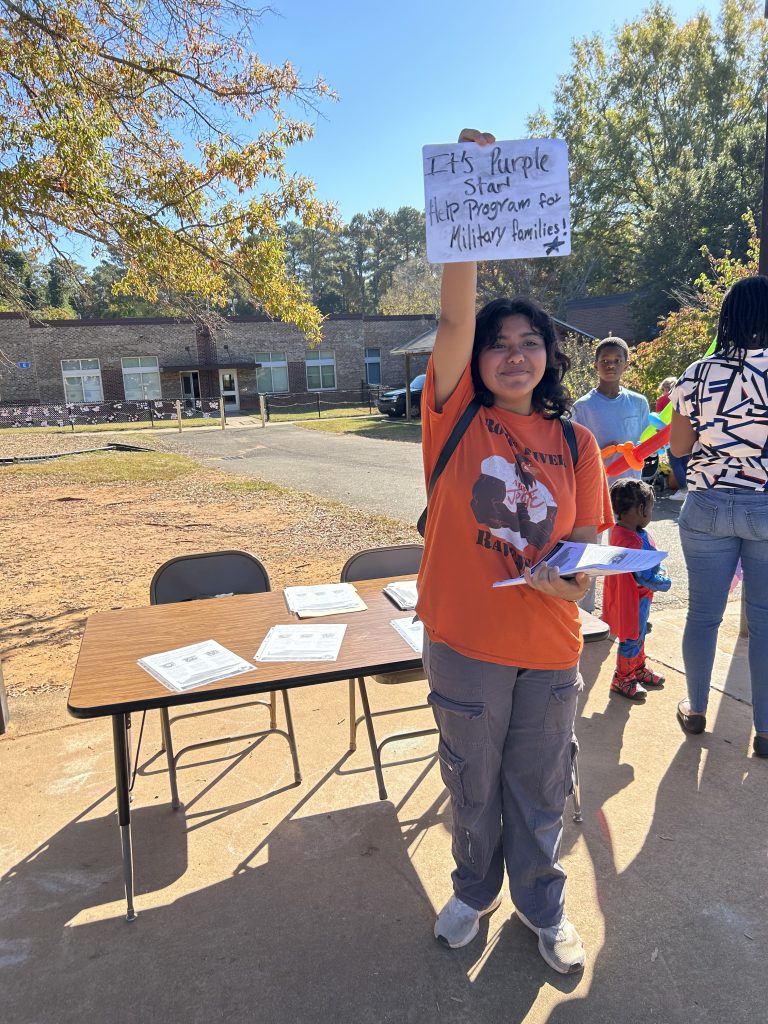 Cadet Mezza advertises Purple Star Families at Reedy Creek Elementary Fall Festival.