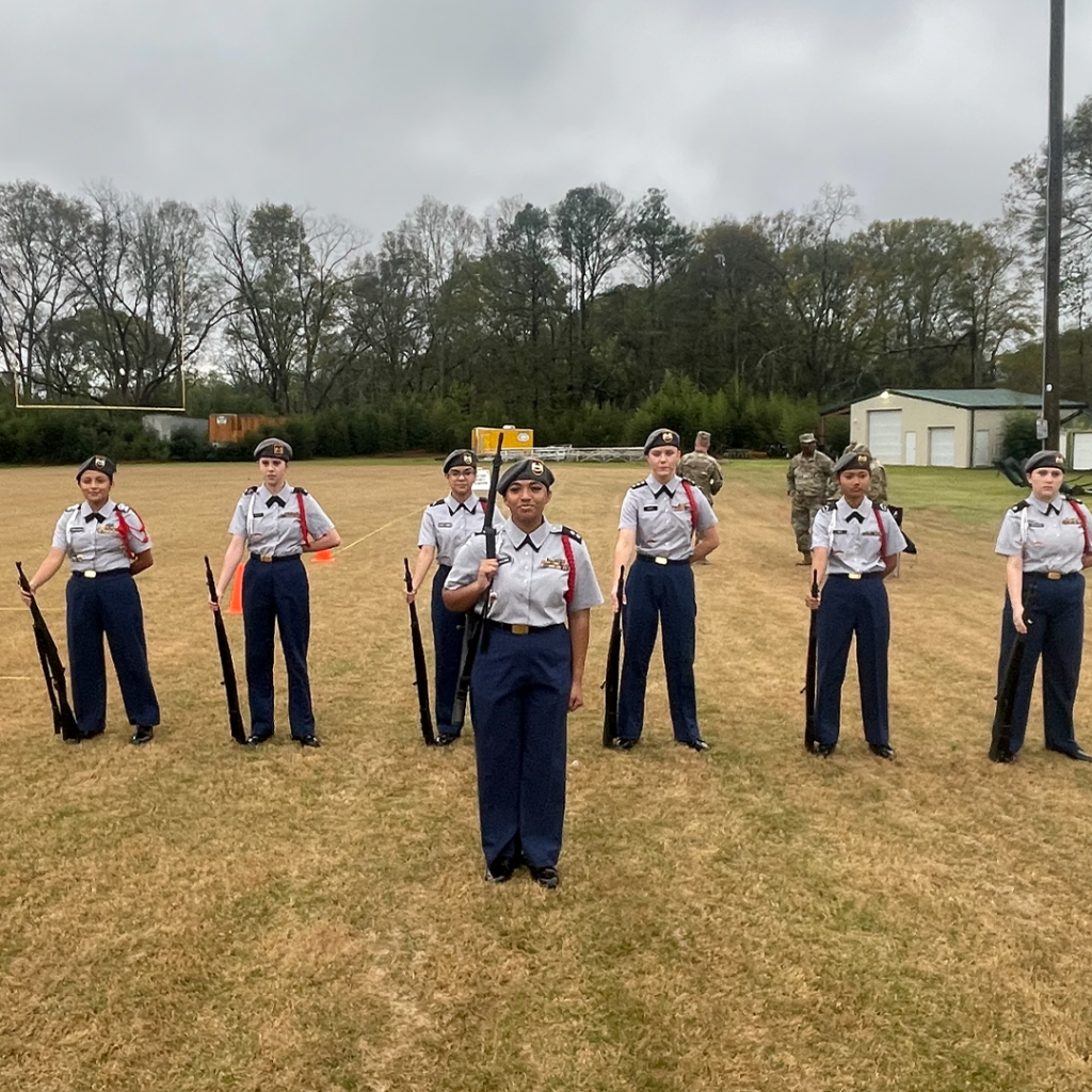Pictured left to right: is the all-female armed squad winning its first state championship in program history.. The squad includes; Drill Commander C/2LT Gizele Collins (front and center), C/CSM Carmen Denova- Antonio, C/SSG Brandy Wood, C/PFC Saory Lopez-Gomez, C/CPT Ava Grace-Smith, C/SSG Say Bo, and C/SGT Lindy Wilson