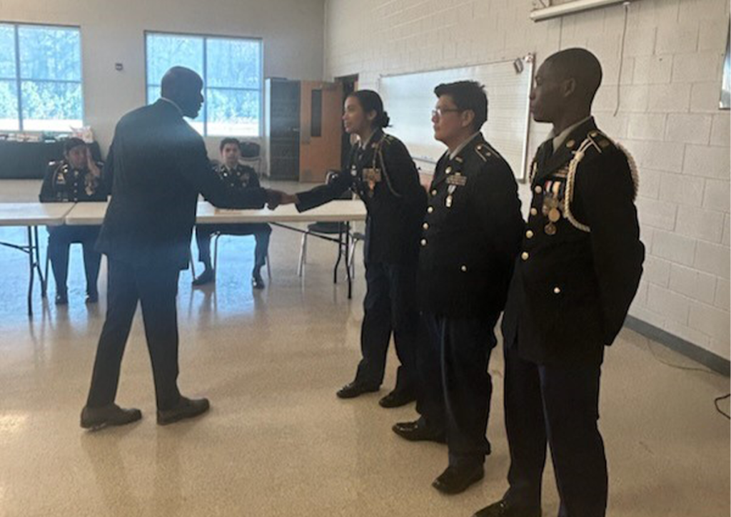 4th Brigade, Operations and Training Chief, Mr. Diron Reynolds presents awards to UHS Cadets during their JPA