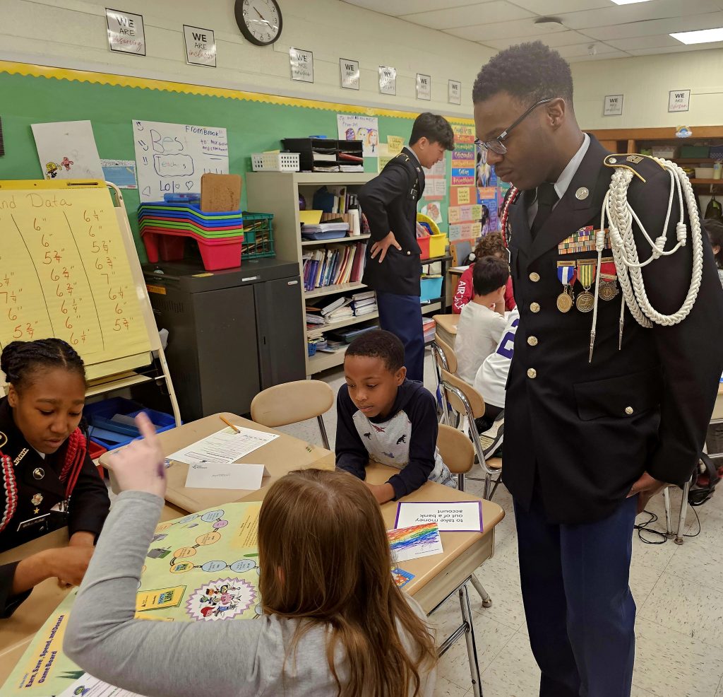 Cadets Jordan Witherspoon and Mackenzie Guillaume assist their 3rd grade class with an activity.
