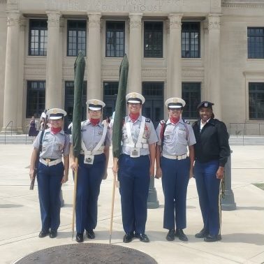 The Olympic High School JROTC Color Guard standing before the courthouse