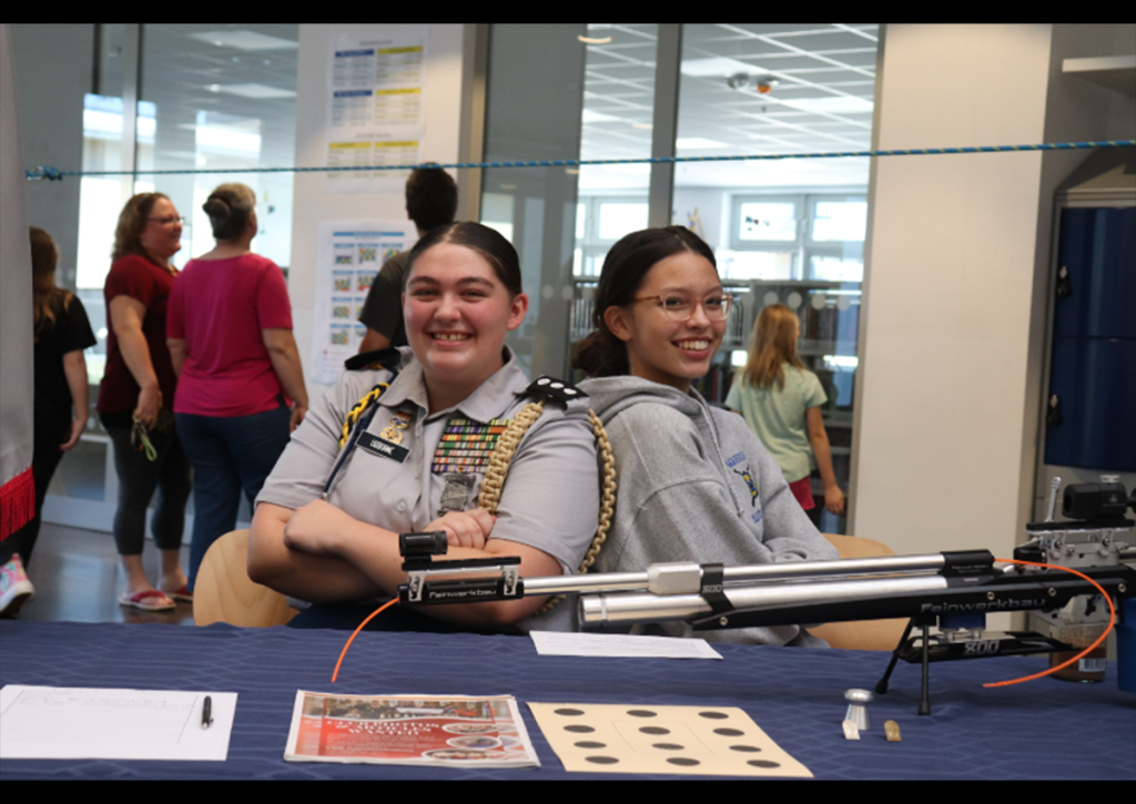 C/CPT Teagan Osborne shows an air rifle from the varsity marksmanship team. (Photo taken by C/CPT Avah Wetherwax)