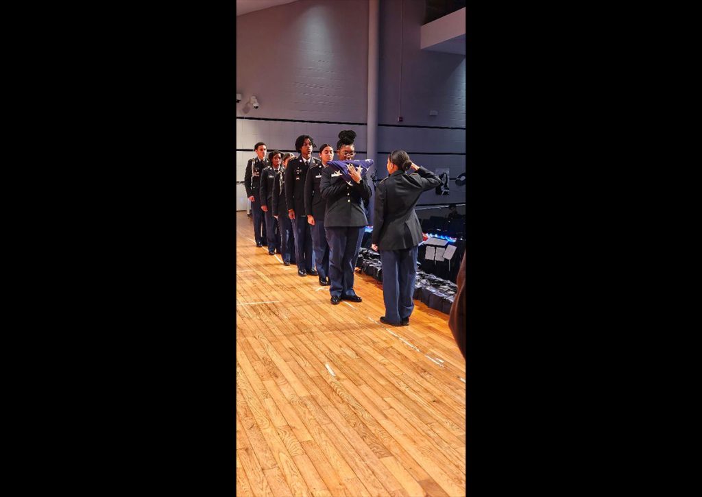 Hillhouse JROTC cadets performing a flag passing ceremony.