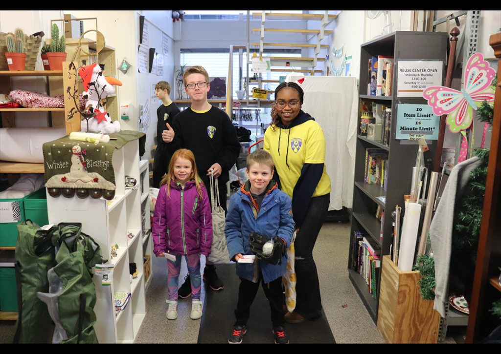 Cadets Celine and McBride assist kids in selecting gifts (Photo taken by C/SSG Preston Blake)