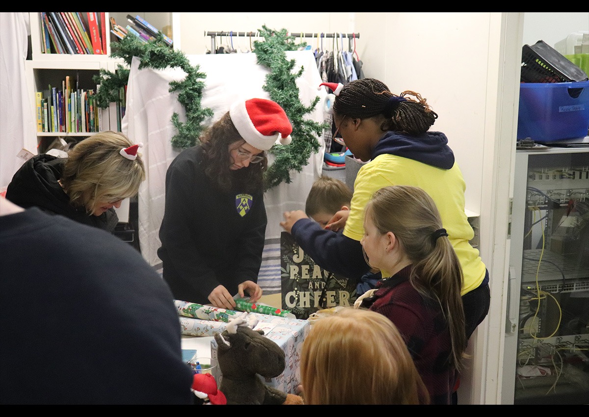 Cadets wrap gifts for the children (Photo taken by C/SSG Preston Blake)