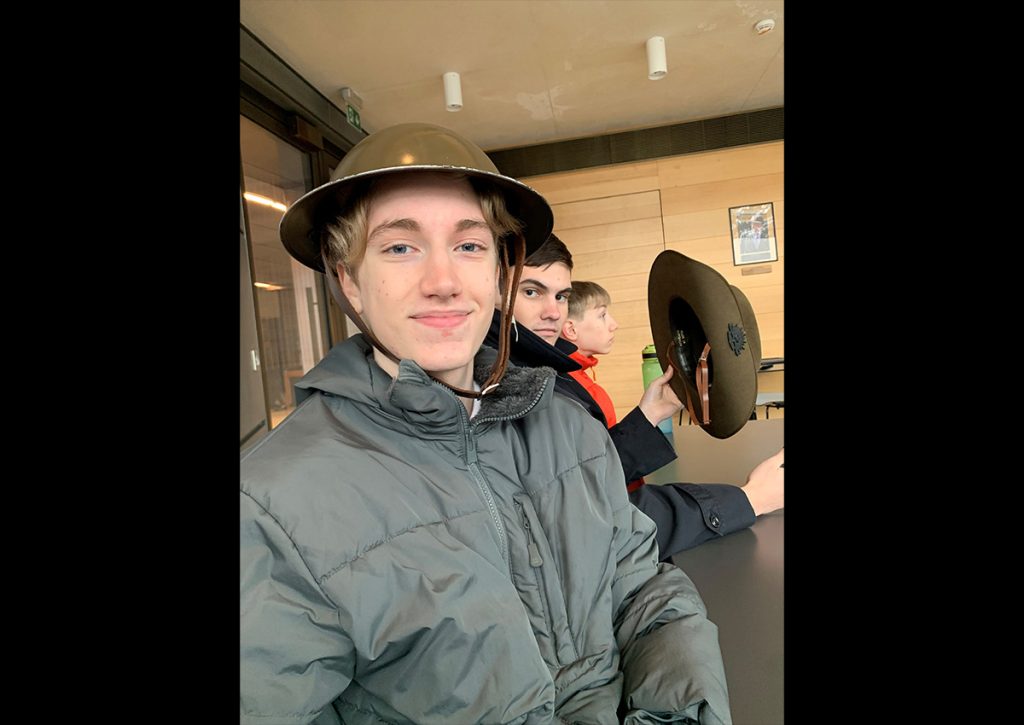 Cadets try on head coverings worn by Australian soldiers in WWI at the Sir John Monash Centre
