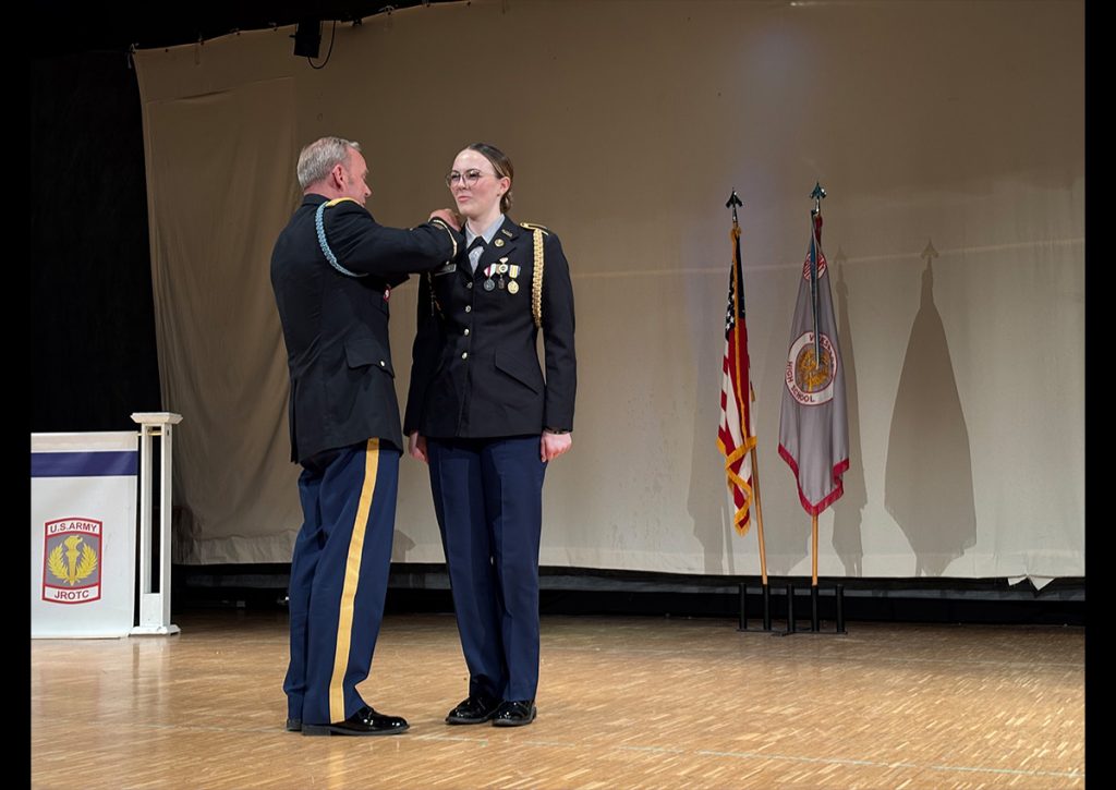 SAI LTC John Ring putting new ranks on Cadet LTC Cydnee Lassiter's uniform during her promotion. (Photo taken by C/CPT Avah Wetherwax).