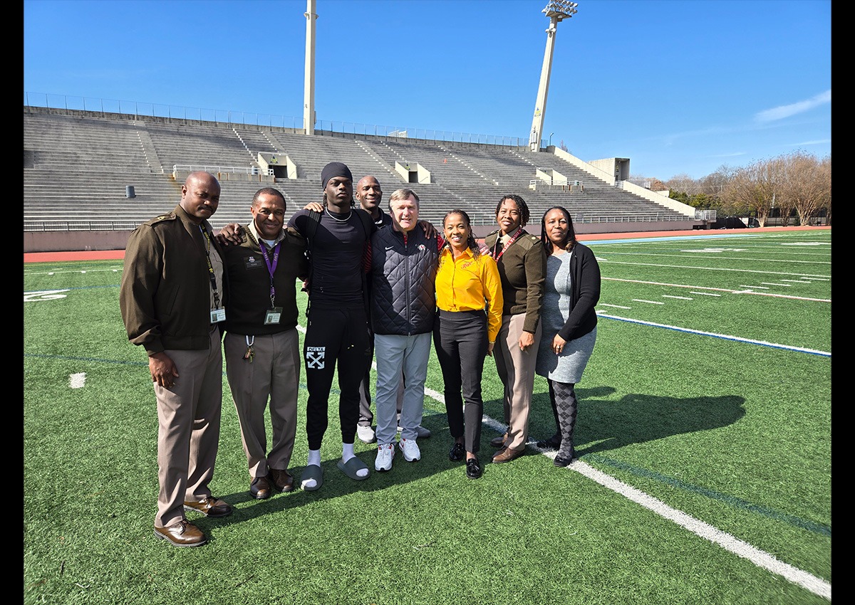 Pictured (left to right) SFC DeCarlo Tyson (AI), SGM Marcus Fisher (AI), Cadet Kentrell White, Coach Kirby Smart, SGM James Harris (APS DDAI), Dr. Mona Venning (APS DAI), Maj Veleka Douglas (SAI), Mrs. Stephanie Love (APS JROTC Admin Asst).