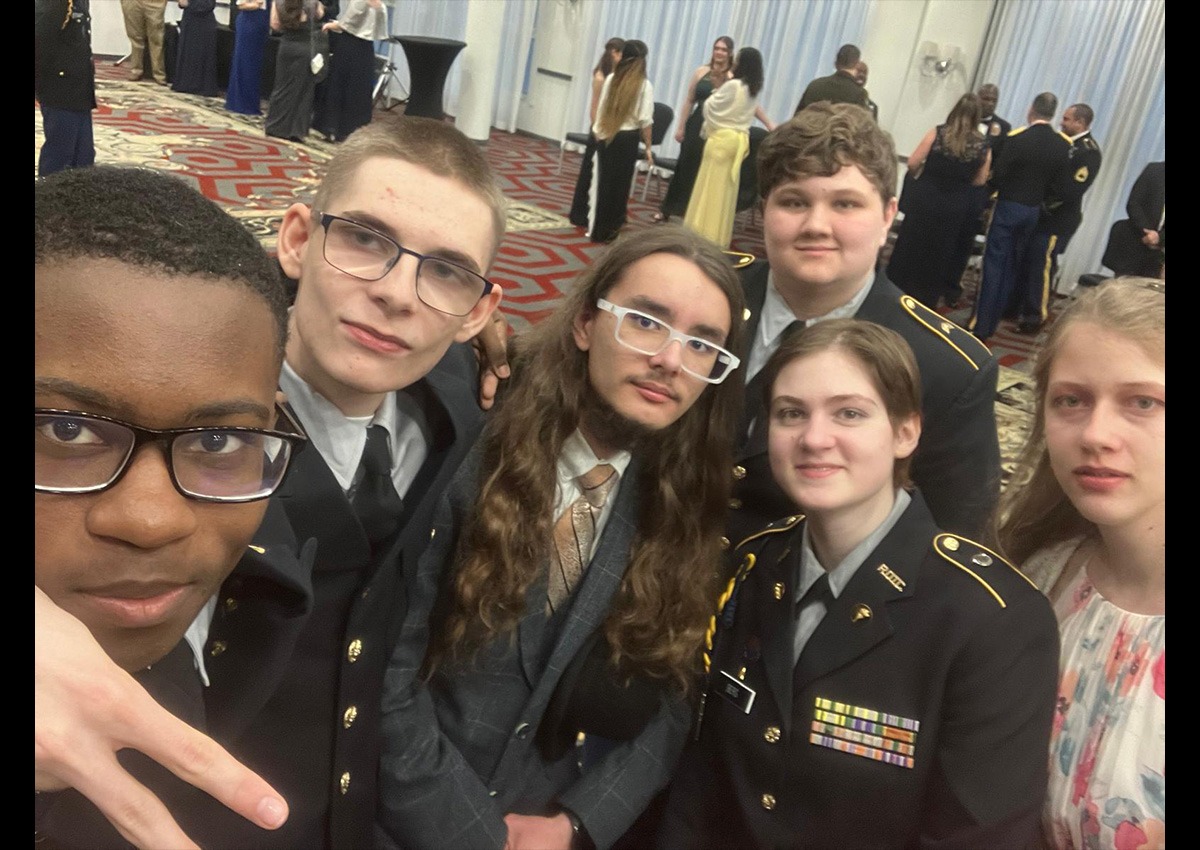 (From left to right) C/CPL Donnovan Wade, Cadet Kyran Latham, guest Timothy Savage, C/SGT Sasha Hunter, C/2LT Elizabeth Berg, and C/SGT Eveln Thayer posing together on the dance floor.