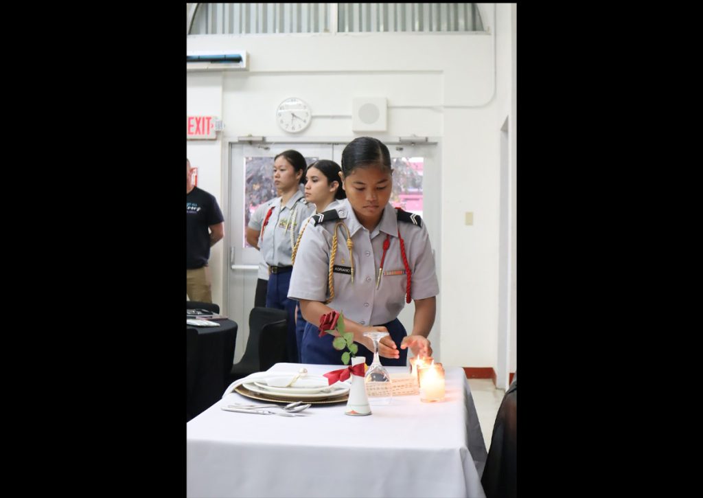 C/CPL Kya Adriano placing down a candle for the “Fallen Comrade Ceremony.”