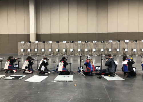 East Denver HS, CO's Army JROTC team (four on left side) and Fountain Fort Carson HS, CO's Army JROTC team (three on right side starting in lane 40) in kneeling position for Precision