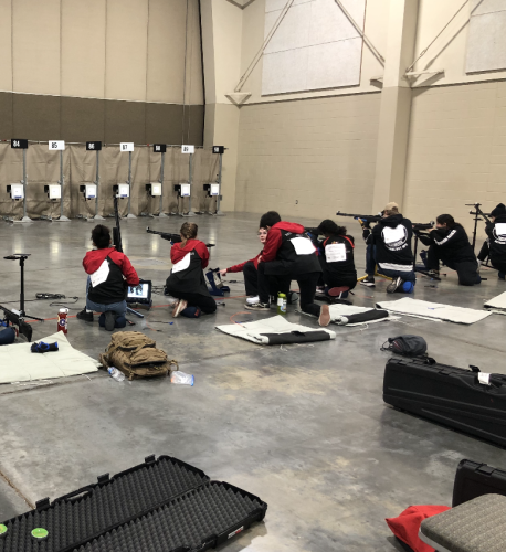 East HS, CO's Army JROTC team (four in red) and Denver South HS, CO's Army JROTC team in kneeling position for sporter