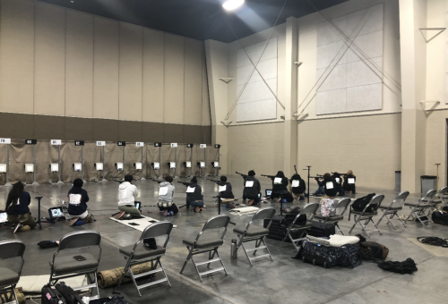 Punahou HS, HI and Pueblo County HS, CO's Army JROTC teams in kneeling position shooting sporter